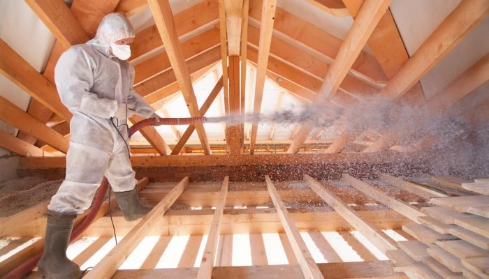A,Man,Is,Spraying,Ecowool,Insulation,In,The,Attic,Of A,Man,Is,Spraying,Ecowool,Insulation,In,The,Attic,Of